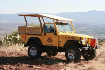 yellow jeep against the sedona red rock landscape