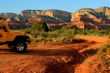 yellow jeep parked in the red rocks of sedona arizona